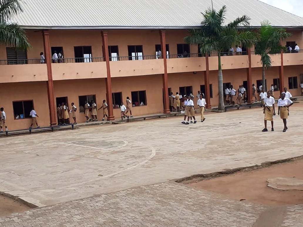 Students outside the main classroom block at break